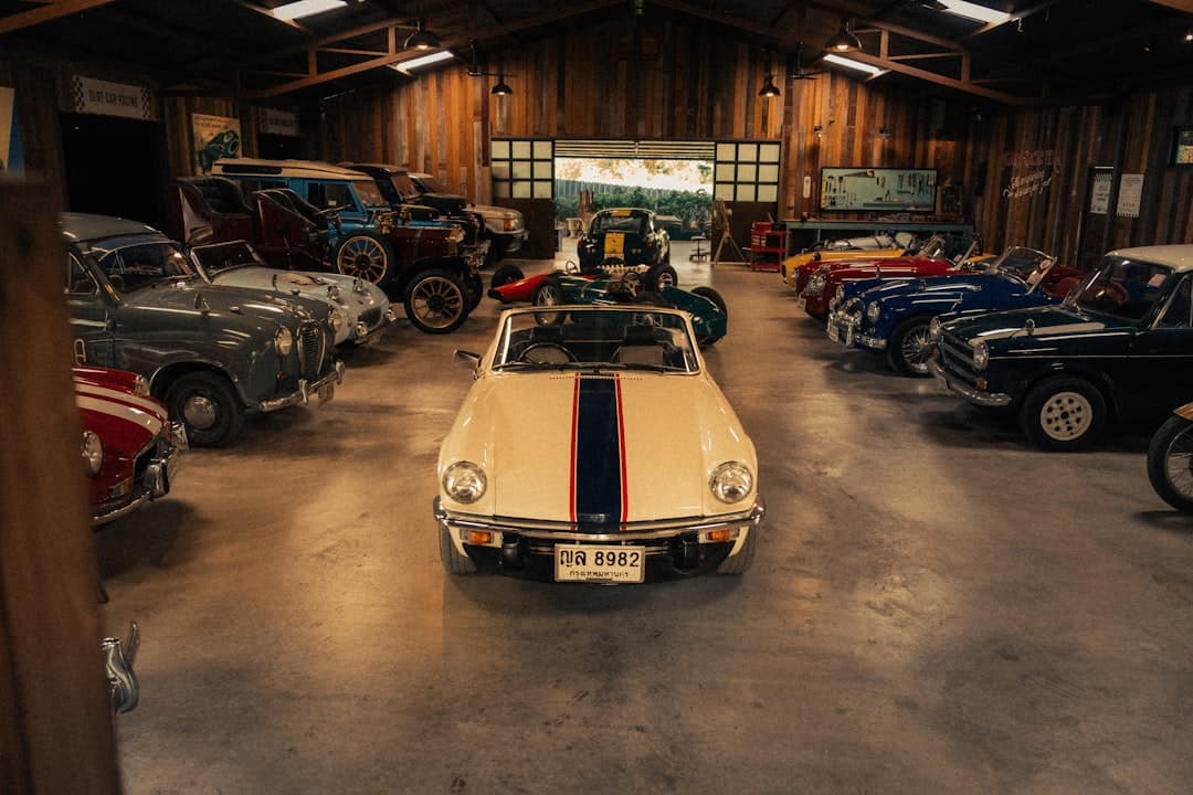 Vintage cars displayed in a spacious wooden garage